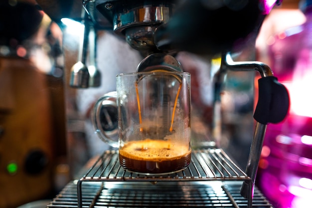 Expresso coffee dripping from the machine