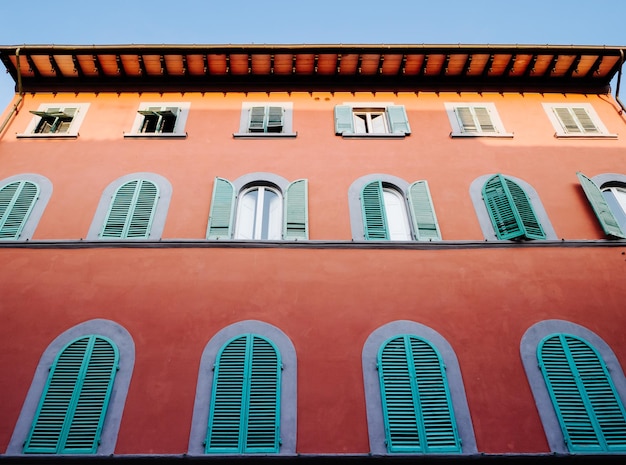 Exquisitely decorated italian facade walls with pivoting windows in an old historic building