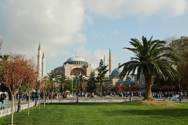 Exterior of Hagia Sophia, a park with tourists and locals resting in the park