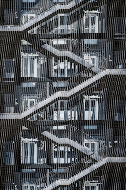 Exterior stairway of an urban building covered with a metallic grid fence