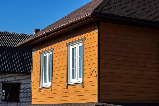 Exterior view of wooden house and two windows