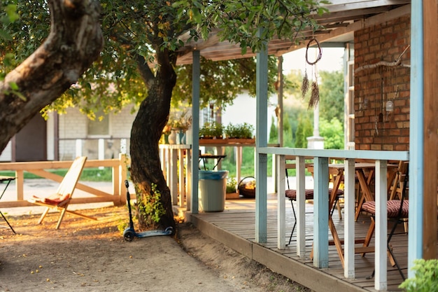 Exterior wall cottage house with veranda and garden.