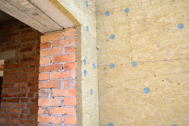 Exterior wall heat isolation with mineral wool in private house building under construction