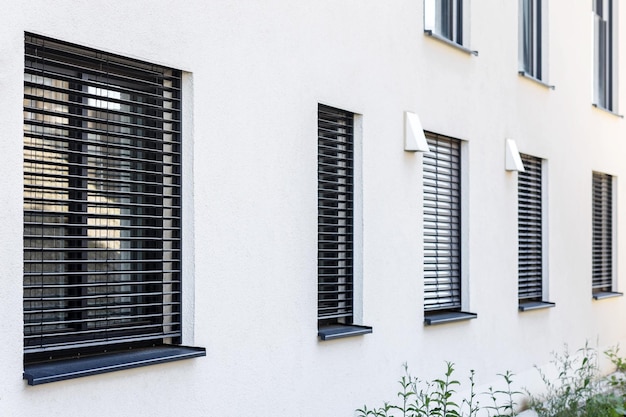 External Roller Blinds on Modern Windows Outside. External Shutters on Windows of House.