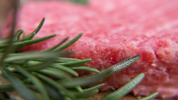 Extra close up Photo with rosemary and minced meat for cutlets. Macro image of food