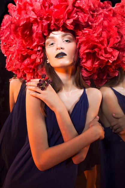 Extravagant young woman's portrait in the twisted halloween outfit and make-up.