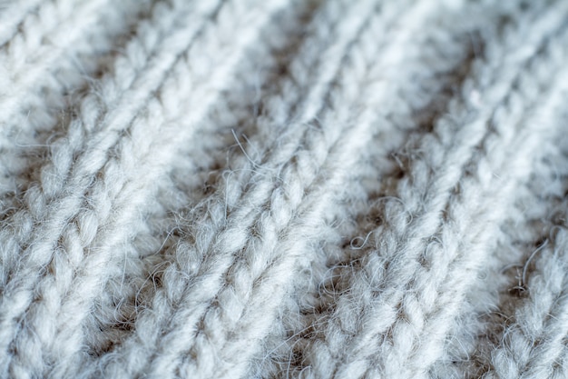 Extreme close-up gray color knitted sweater made of natural wool texture