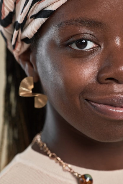 Extreme close up portrait of young africanamerican woman wearing ethnic style and looking at camera ...