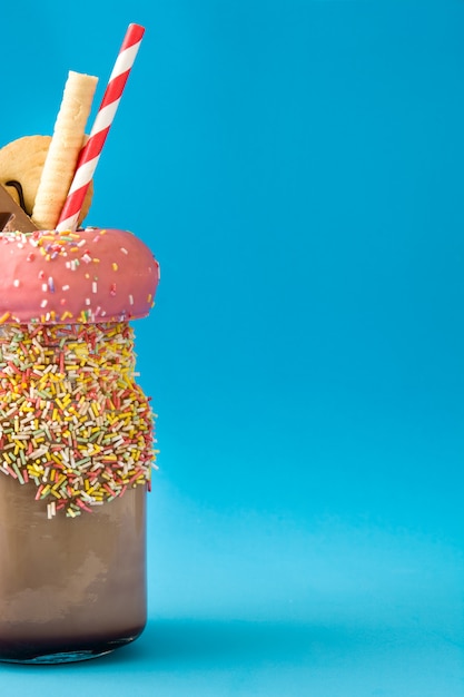 Extreme milkshake or freak shake isolated on blue copy space