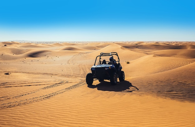 Extreme riding quad buggy bike at sand dunes in Dubai desert safari tour