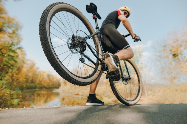 Extreme sportsman spectacularly rides a bicycle in the forest