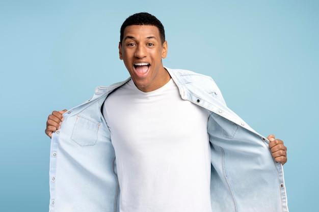 Extremely excited satisfied man having fun resting and rejoicing Indoor studio shot