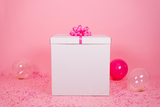 Extremely huge birthday valentine's day mom's day present in the room with pink balloons