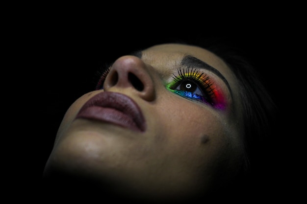 Eye-catching vivid makeup eye details of a young girl. LGBT homosexual flag makeup