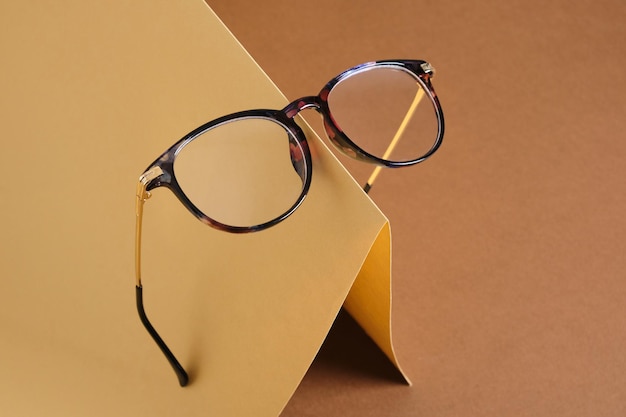 Eye glasses on paper brown and beige background vision concept