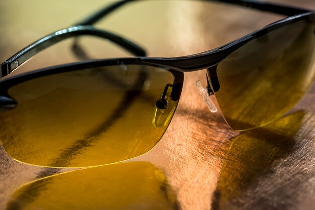 Photo eyeglasses isolated on gold. close up