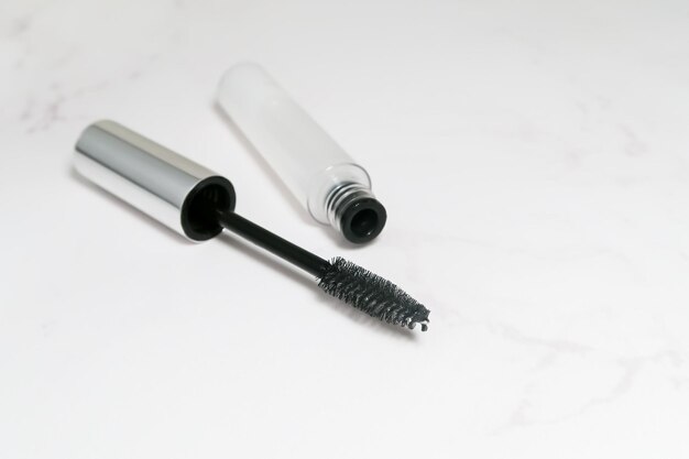 Photo eyelash and eyebrow care serum in a transparent bottle with a brush