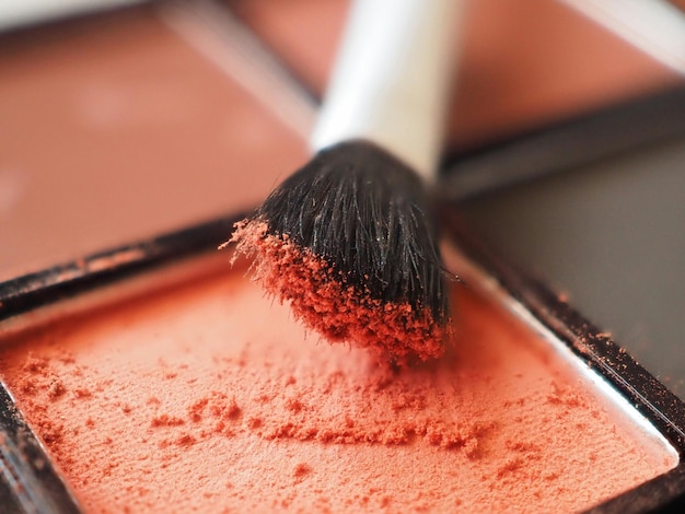 Eyeshadow and brush Closeup of bright terracotta eyeshadows