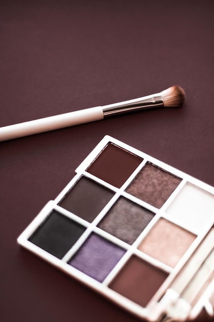 Eyeshadow palette and makeup brush on chocolate background eye shadows cosmetics product for luxury beauty brand promotion and holiday fashion blog design