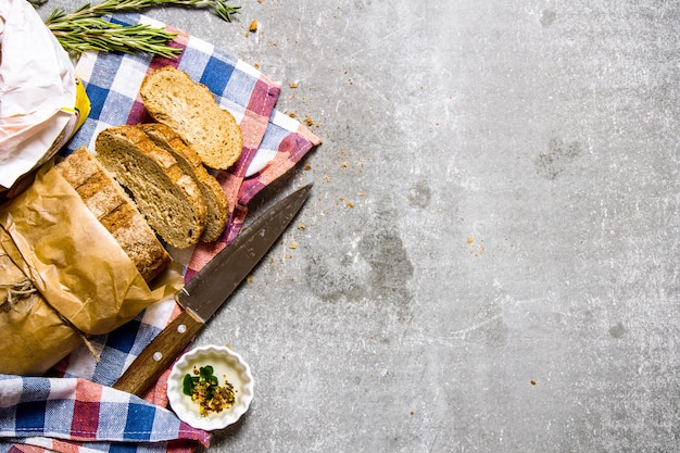 The fabric on ciabatta with rosemary and a knife.