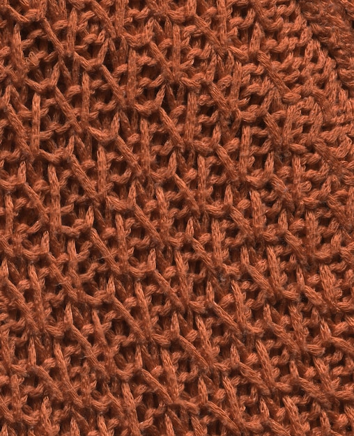 Fabric coffee colored texture for background and design. Brownish colored abstract woven knitwear textile background.