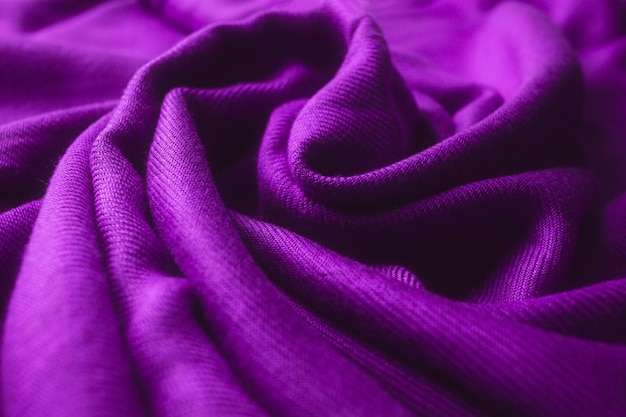 Fabric texture background of purple color (Very Peri). Close up of clothes as wallpaper.