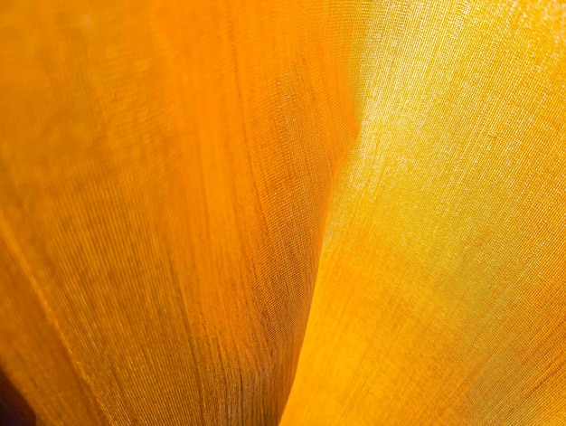 Photo fabric texture of natural yellow or golden colour khadi fabric fabric textured of cotton or linen