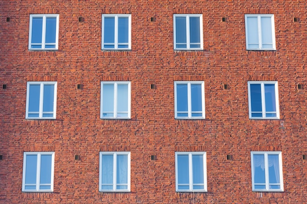 Facade of the building with white-framed residential building.