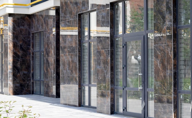 Facade of commercial premises with panoramic windows at street level in a new modern residential complex Commercial real estate for rent in a typical building