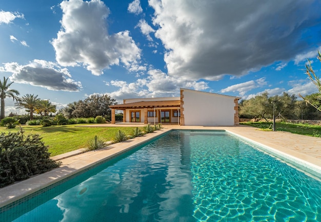 Facade of a country house in majorca seen from the swimming pool