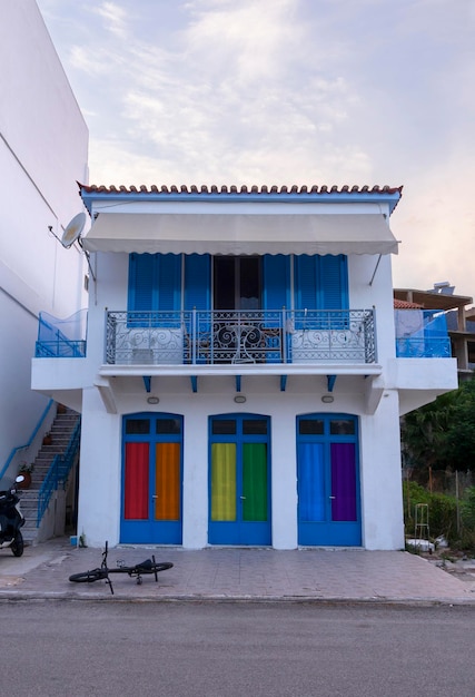 Facade of a house with curtains in the colors of the LGBT flag in the resort town in Greece