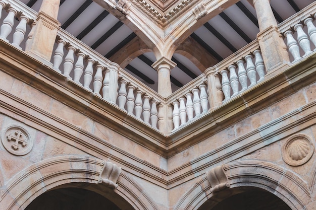 Facade of medieval church with balcony. Old church. Symmetry in ancient architecture details.