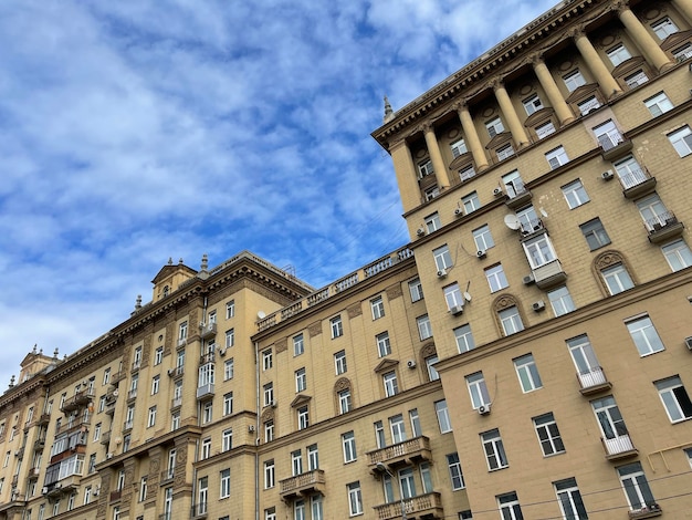 Facade of a multistorey panel building Residential building with many apartments Apartment house old architecture residential building