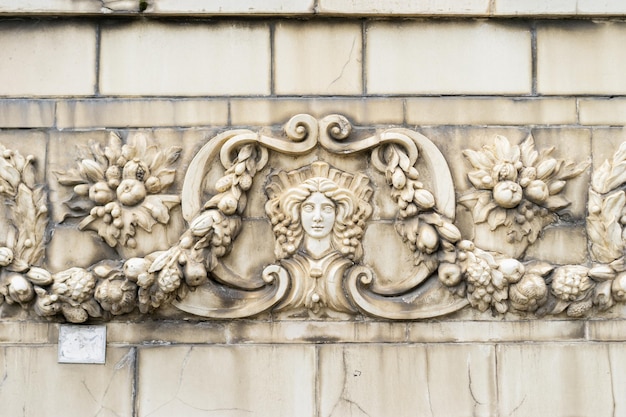 The facade of an old building decorated with a pattern of stucco Mythical creatures of an old house