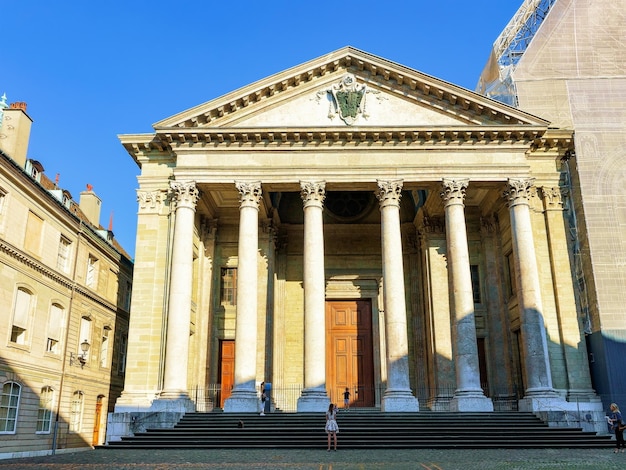 Facade of St Pierre Cathedral in the old town of Geneva, Switzerland. People on the background