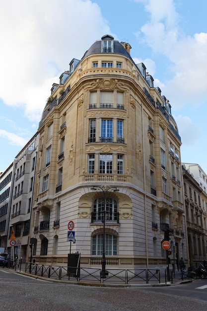 The facade of traditional french house with typical balconies and windows paris france