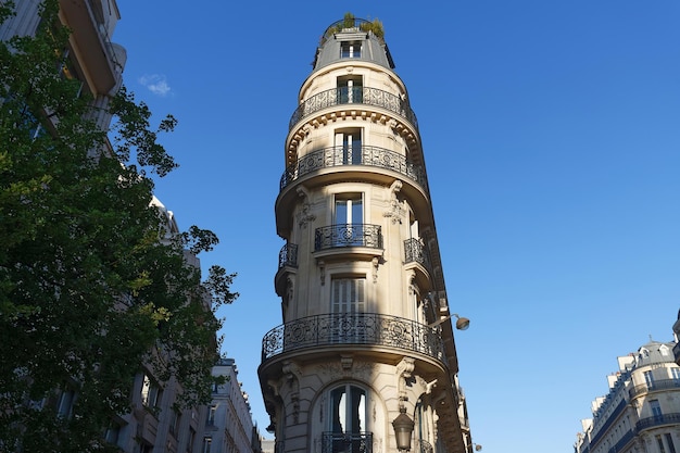 The facade of traditional French house with typical balconies and windows Paris