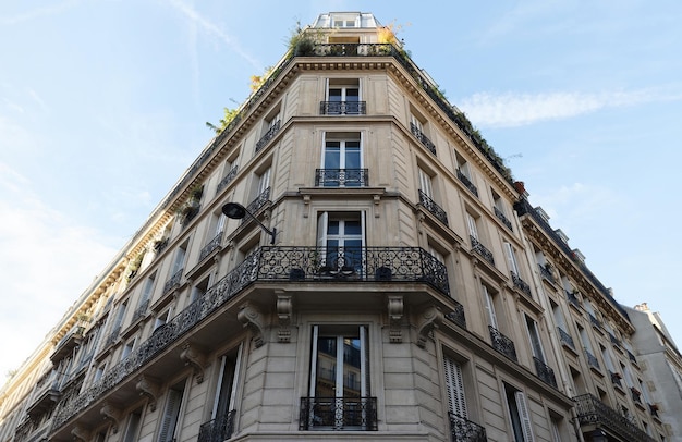 The facade of traditional French house with typical balconies and windows Paris