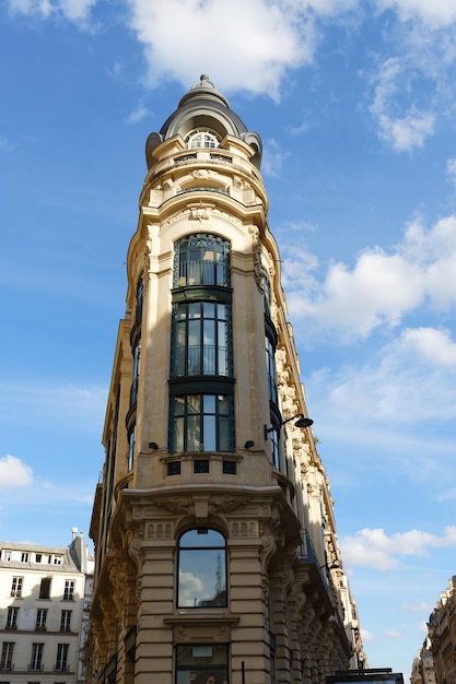 The facade of traditional French house with typical balconies and windows Paris