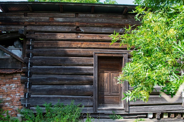 Facade wall made of old rotten wood. Beautiful backgrounds. Country life