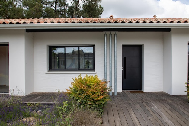 Photo facade of white modern house with terrace wooden of new suburban home