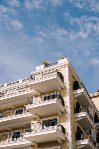 Facade with terraces of the regent hotel against the sky porto montenegro