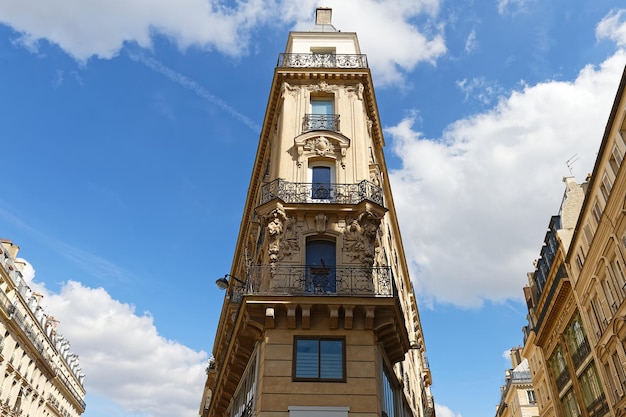 The facades of traditional French houses with typical balconies and windows Paris