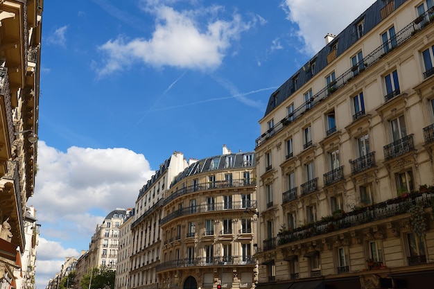 The facades of traditional French houses with typical balconies and windows Paris