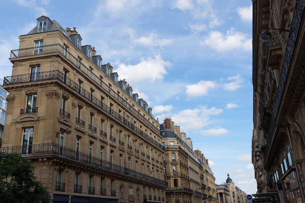 The facades of traditional French houses with typical balconies and windows Paris