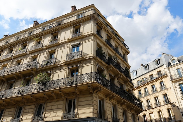 The facades of traditional French houses with typical balconies and windows Paris