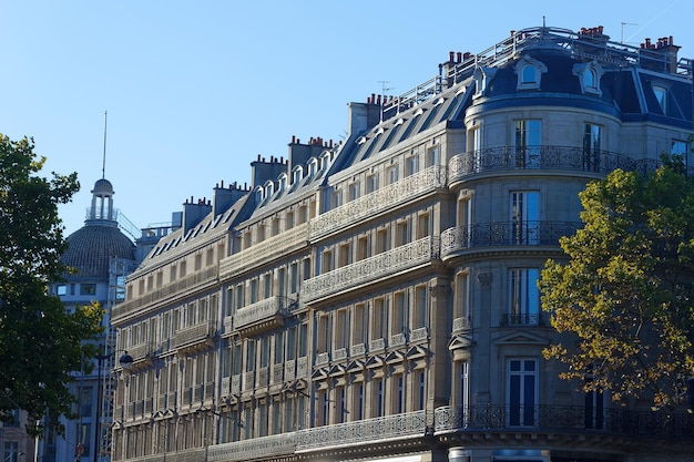 The facades of traditional French houses with typical balconies and windows Paris