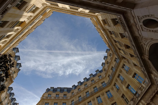 The facades of traditional French houses with typical balconies and windows Paris