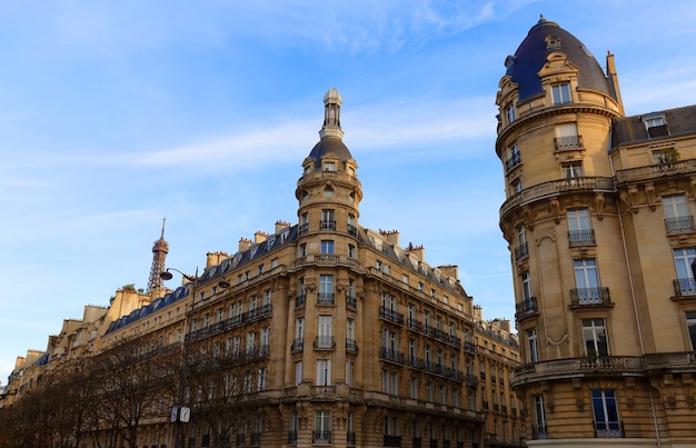 The facades of traditional French houses with typical balconies and windows Paris