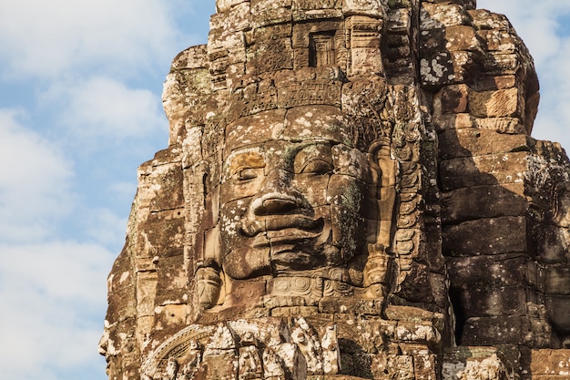 Face of Ancient bayon on blue sky, Cambodia